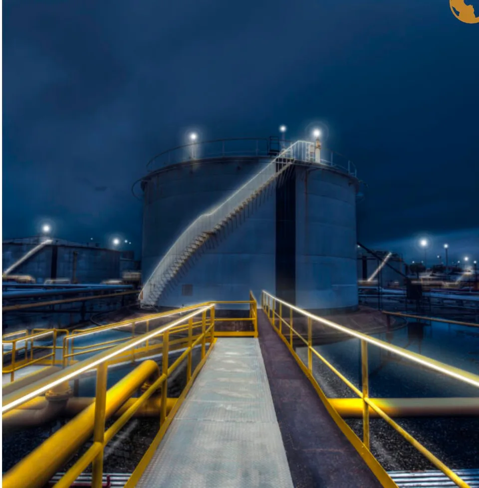 Storage tank with lit access walkway at night