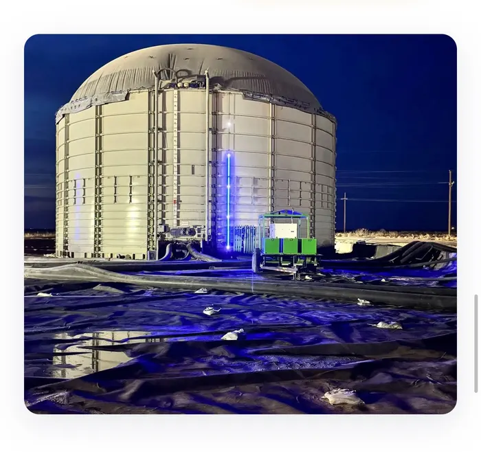 Large storage tank at night with a SHIELD blue LED level indicator