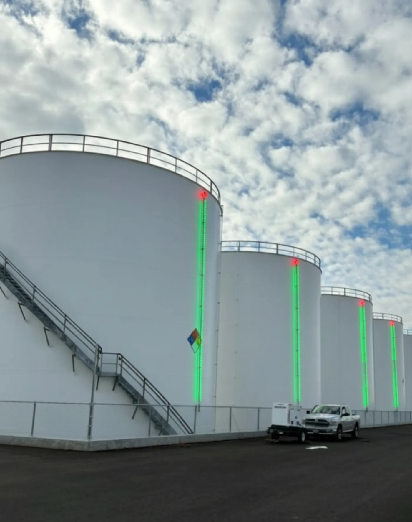 Row of tanks in daylight fitted with SHIELD green LED level bars