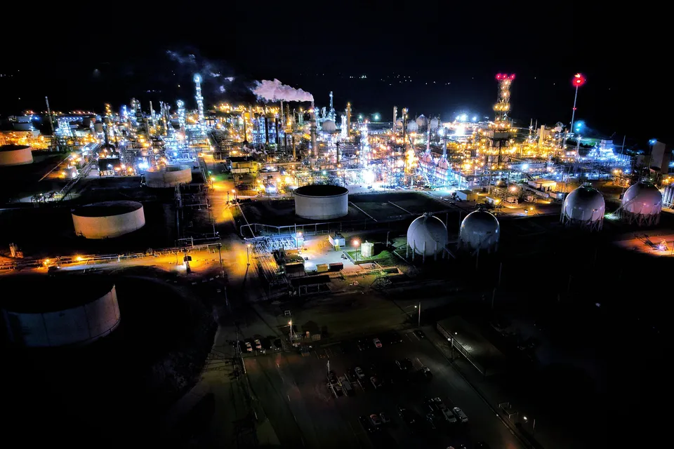 Stunning aerial view of a brightly lit refinery in El Dorado, Kansas showcasing industrial architecture.