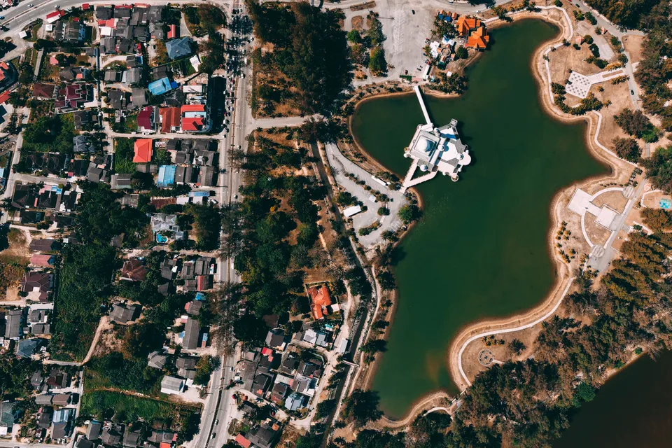 An aerial photo showcasing a vibrant urban landscape adjacent to a serene lake.